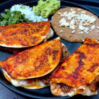 Tacos de Shortrib · 3 pieces. Barbacoa de costilla con queso Manchego en tortilla sumergida en salsa de asado de...