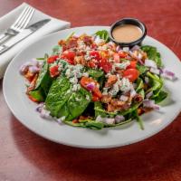 Spinach Salad · Served with roasted peppers, bacon, tomatoes, onions & bleu cheese crumbles.