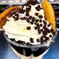 Chocolate Chip Cookie · A warm jumbo chocolate chip cookie split in half on top of cookie dough ice cream and hot fu...