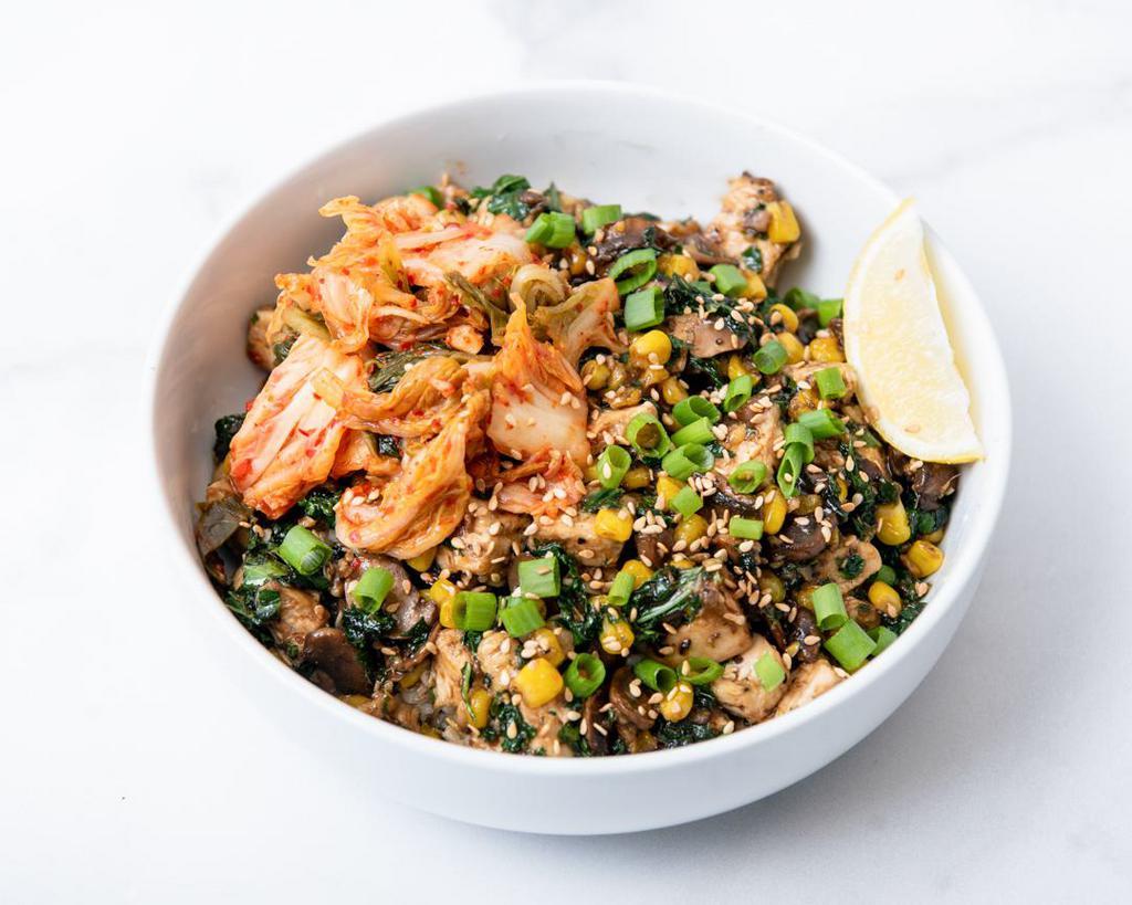 Gluten-Free Sweet Chicken Kimchi · Antibiotic-free roasted chicken with kimchi, roasted corn, sauteed mushrooms, citrus-marinated kale, caramelized onions, green onions, sesame seeds, and sweet Korean bbq sauce. Served with a lemon wedge and a base of your choice. (Gluten-Free)