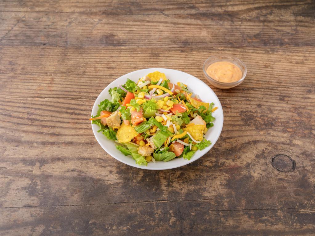 Fiesta Chicken Salad · Home fried chicken, romaine lettuce, mixed cheddar and Jack cheese, corn, tomato, red onions and tortilla strips mixed with smoky chipotle dressing.