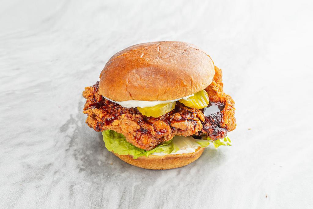 Soy Garlic Fried Chicken Sandwich · Deep fried chicken thigh glazed with soy garlic sauce. Served on a potato roll with mayo, lettuce, and pickles. 
Contains: Gluten, Eggs, Soy