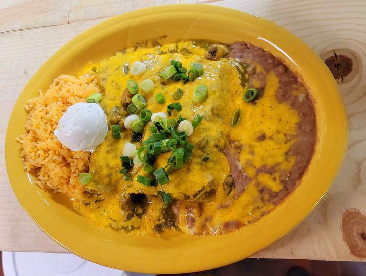 Enchiladas Verdes · 3 corn tortillas rolled and stuffed with pork, covered with our light green tomatillo sauce and topped with melted cheese. Garnished with sour cream and green onions.