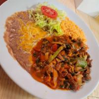 Steak Tampiquena · Strips of beef tenderloin, onions and bell peppers sauteed in a Mexican sauce. Garnished wit...