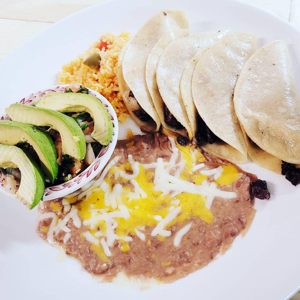 Tacos de Carne Asada · 4 soft corn tortillas filled with our special tender steak. Served with cilantro, onions and avocado.
