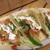 Blackened Fish Tacos · Three soft tacos stuffed with tomatoes, cilantro, lettuce, guacamole and sour cream.