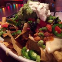 Loaded Nachos · Turkey chili, tomatoes, jalapenos, onions, olives, pepper jack queso and sour cream.
