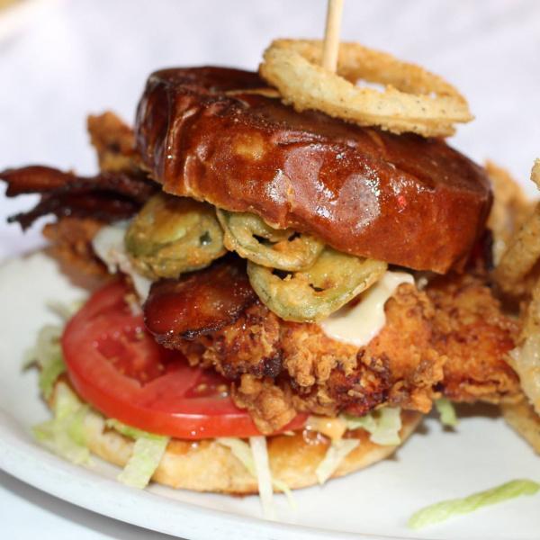 Spicy Chicken Sandwich · Grilled or fried chicken with jalapeno bacon, pepper jack cheese, fried jalapenos, lettuce, tomato and chipotle aioli. Served with your choice of side.
