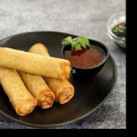 Spring Roll · 4 pieces. Rice paper or crispy dough filled with shredded vegetables. 