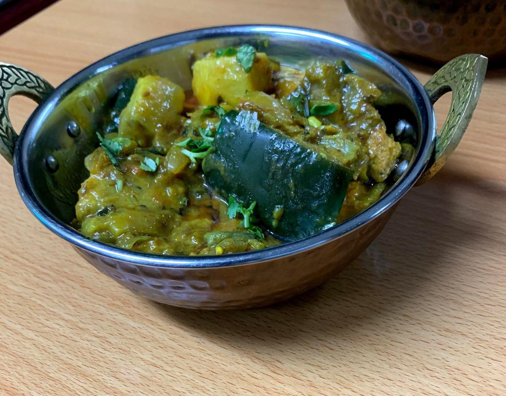 Aloo Baingan · Potatoes and eggplant cooked with onions, tomatoes and spices. 