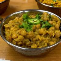Channa Masala · Chickpeas boiled then cooked with chopped onions, chopped tomatoes, turmeric powder, cumin a...