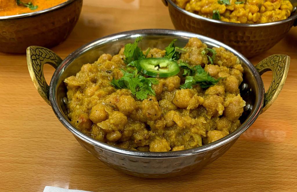 Channa Masala · Chickpeas boiled then cooked with chopped onions, chopped tomatoes, turmeric powder, cumin and coriander seeds with curry leaves. 