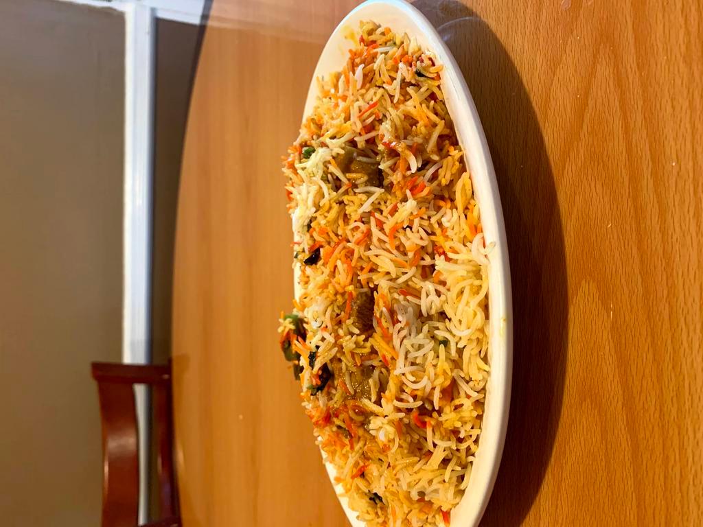 Chicken Biriyani · Spiced chicken and nuts cooked in herbs and spices with basmati rice. 