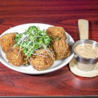 Boudin Balls · 5 golden fried boundin bites battered in Japanese bread crumbs served with remoulade sauce.