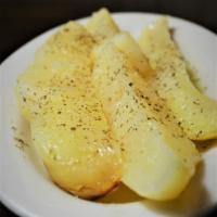 Patates Fournou · Oven roasted lemon potatoes seasoned with extra virgin olive oil and oregano.
