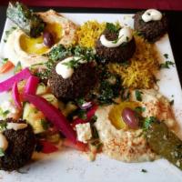 14. Falafel Combo Plate · Falafel, tabbouleh, grape leaves, hummus, babaganouj, rice and salad. Vegetarian.