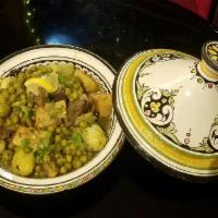 2. Lamb Tagine · Shank of lamb, artichoke, sweet peas, potato and olives simmered with a bouquet of herbs and...