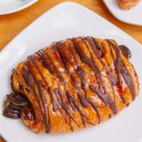 Chocolate Croissant · A flaky French pastry with a chocolate spread inside and drizzle on top