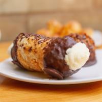 Cannoli · A cylinder of puff pastry rolled in sugar, dipped in dark chocolate, and filled with whipped...