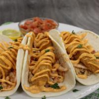 Fish Taco Trio · A wonderful, potato encrusted cod nestled in soft flour tortillas, topped with taco rice, pi...