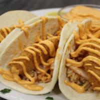 Crispy Chicken Taco · Crispy breaded chicken meat nestled in soft flour tortillas, topped with taco rice, pico de ...