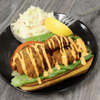 Crispy Chicken Poboy · Crispy, tender chicken breast served on a toasted bun with lettuce, tomato and our creamy Pa...