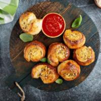Garlic Knots · 8 pieces of classic garlic knots made of strips of pizza dough tied in a knot and topped wit...