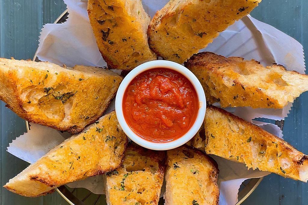 Garlic Bread · Rustic Italian bread toasted with garlic parmesan butter and served with marinara sauce.