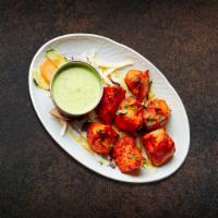 Smoked Chicken Tikka (6 Pcs) · Boneless pieces of chicken marinated and barbecued in a tandoor clay oven.
