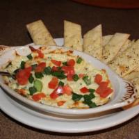 Artichoke Dip · Extra creamy dip is brick fried and served hot with artichoke hearts, roasted garlic, spinac...
