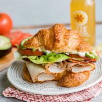 Turkey Croissant Sandwich · Premium deli turkey over a croissant with toppings.