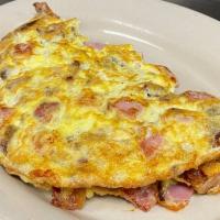 Meat Lover Omelette · Ham, bacon, and sausage omelette served with home-fries and a toast

