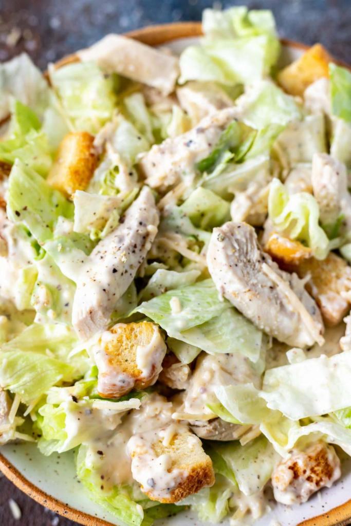 Chicken Caesar Salad · Romain lettuce with Caesar dressing, croutons, chicken, and cheese. 