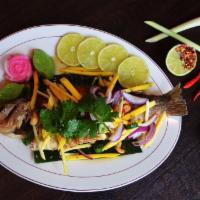 Fried Whole Fish with mango salad · Topped with mango salad and chili lime sauce. Served with rice.