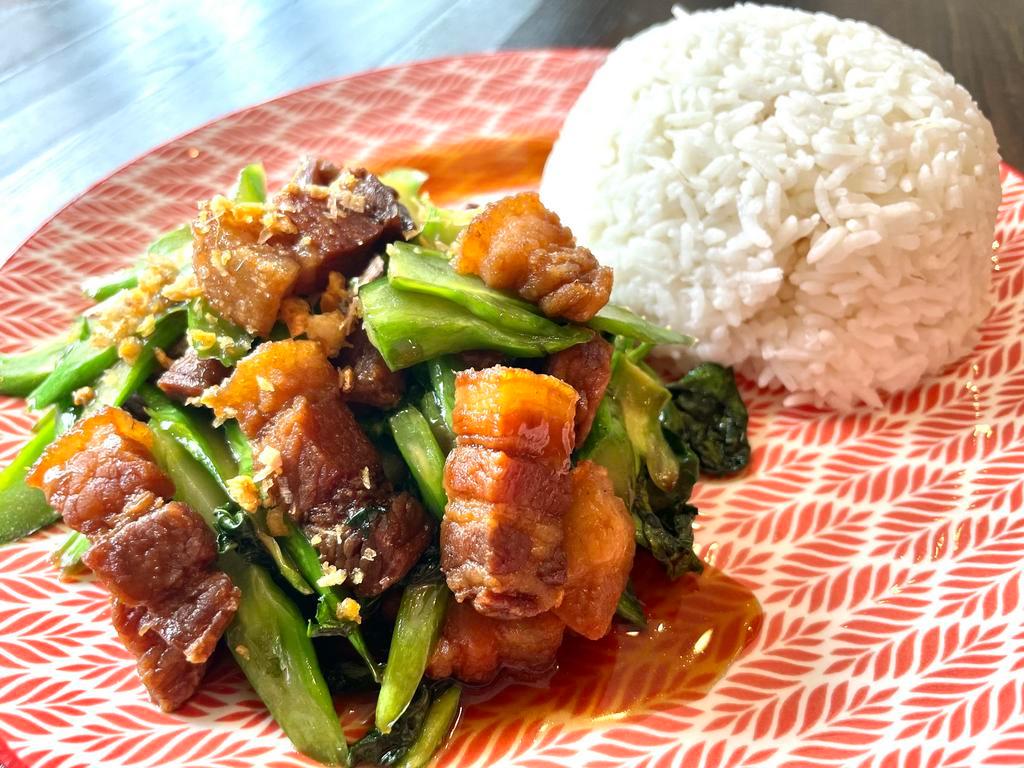 Kana Moo Krob · Crispy pork belly stir fried with garlic, chinese broccoli & homemade sauce. Served with rice. 