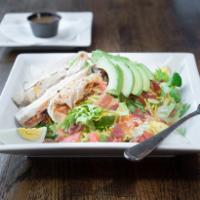 Cobb Salad · Romaine topped with diced tomatoes, bacon bits, hard broiled egg, sliced avocado, mixed chee...