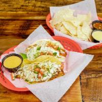 Lu Tacos · Blackened tilapia, white cabbage, pico de gallo and chipotle mayo.  Served with house made c...
