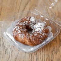 Churro Donut · Churro donut tossed in cinnamon and sugar and dusted with powdered sugar and drizzled in car...