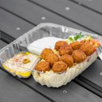 23. Falafel Over Rice Plate · Chick peas mixed with herbs, served with hummus, tahini sauce, salad and pickles. Rice, Tzat...