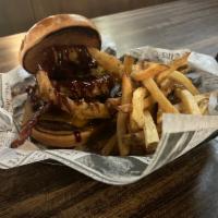 BBQ Bacon Burger · 7 0z brisket patty topped with cheddar cheese, bacon, onion rings and bbq sauce. 