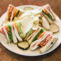 Carmine's Turkey Club · Turkey, lettuce, tomato, dipole ranch, bacon and avocado. Served with coleslaw, pickles and ...
