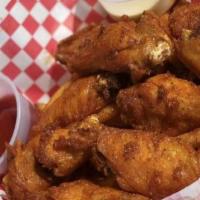 6 Piece Lemon Pepper Wings · Cooked wing of a chicken coated in sauce or seasoning.
