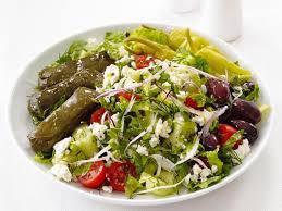 Greek Salad · Crispy lettuce, feta cheese, stuffed grape leaves, tomato, olives and onions. 