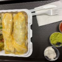 E5. Enchiladas · 2 soft tortilla rolled and stuffed with onion, tomato and guacamole, sour cream with red sau...