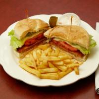 Chicken Cutlet Deluxe Sandwich on a Bun · With lettuce, tomato and french fries.