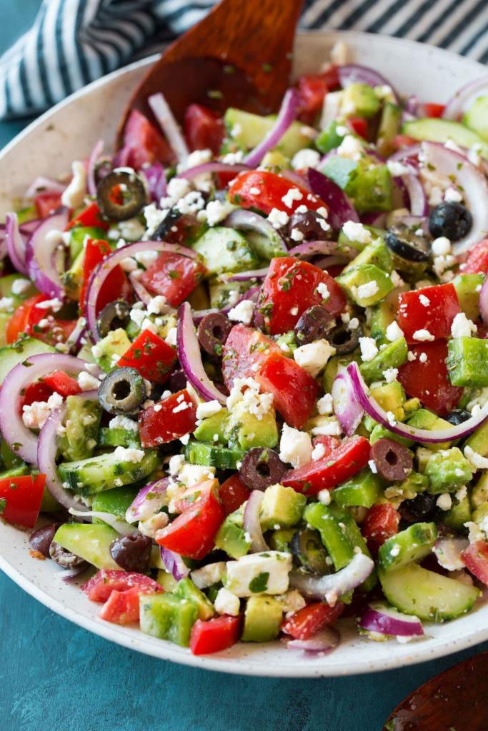 Greek Salad · Feta cheese, lettuce, tomatoes, green peppers, pepperoncini, onions, Kalamata olives and cucumbers.