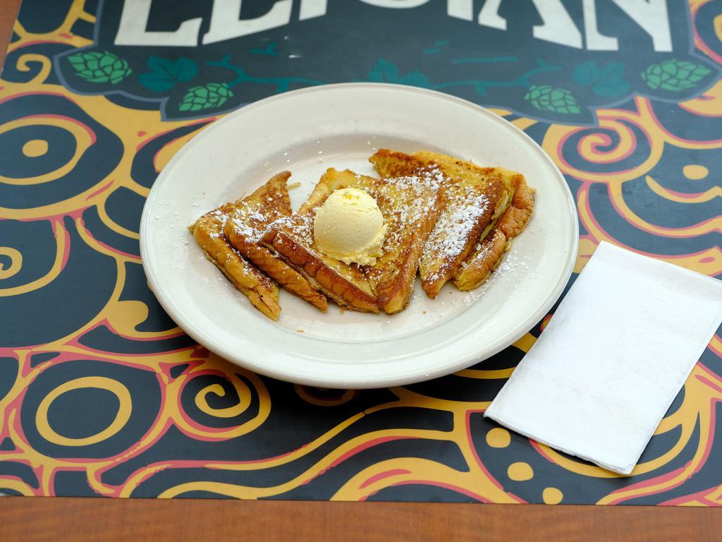 French Toast Breakfast · Thick Texas style bread dipped in a cinnamon-nutmeg egg batter served with butter, maple syrup and powdered sugar.