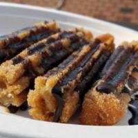 Churros  · Fried pastry dough rolled in cinnamon sugar served with chocolate Abuelita compote.