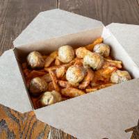 Thunder Balls · Angus Beef Meatballs served over spiced potato wedges covered 
in a tangy Bechamel, BBQ or T...
