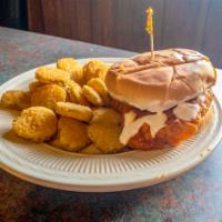 The Fiery Chick · Fried chicken sandwich dipped in buffalo sauce on a brioche bun with ranch and pickles. Serv...